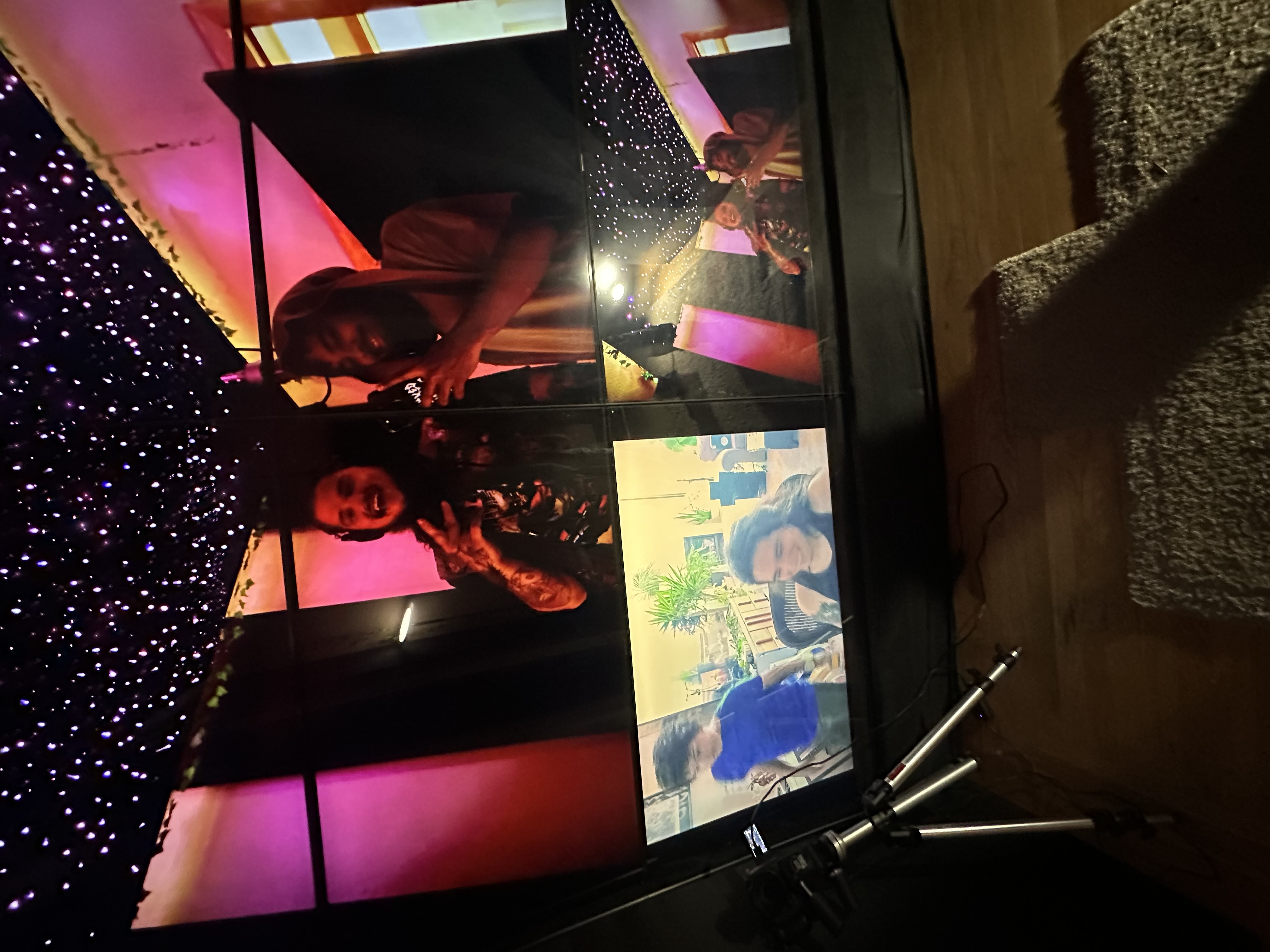 Two artists mid-session in the booth under the star ceiling